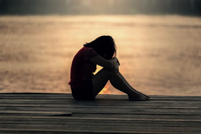 depressed girl sitting alone