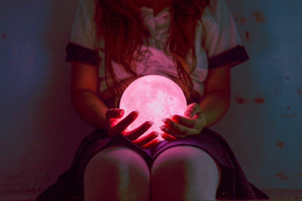 person holding light ball