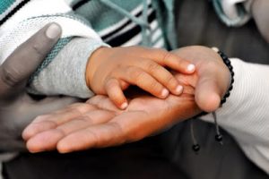 Childs hand on parents hand