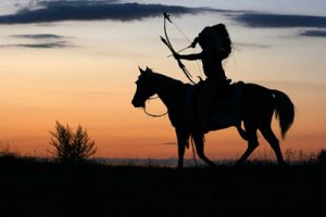 A man on horse with bow and arrow