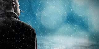 man standing alone in rain