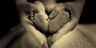baby feet in mothers hand